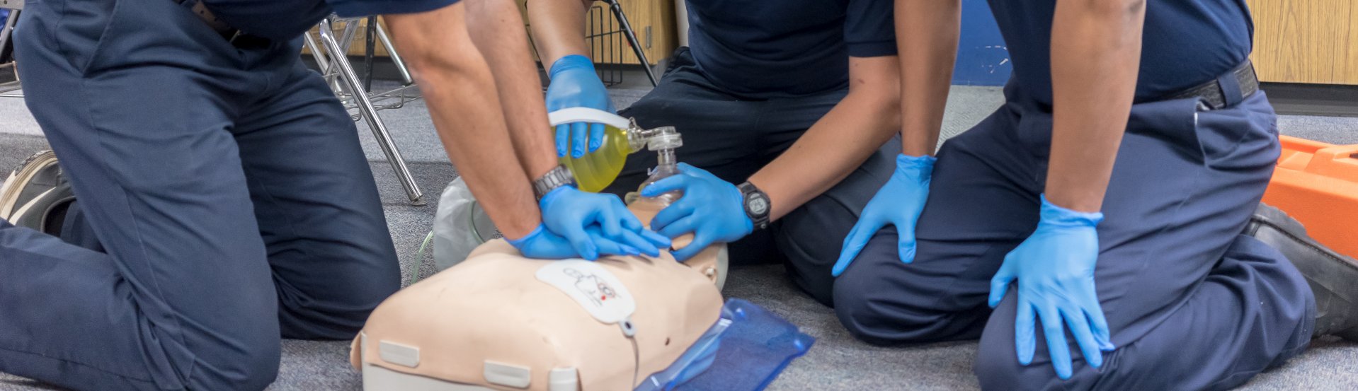 EMT students practicing resuscitation on a dummy