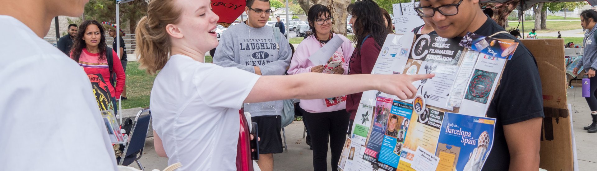 student looking at "walking billboard" advertising available clubs during Club Rush