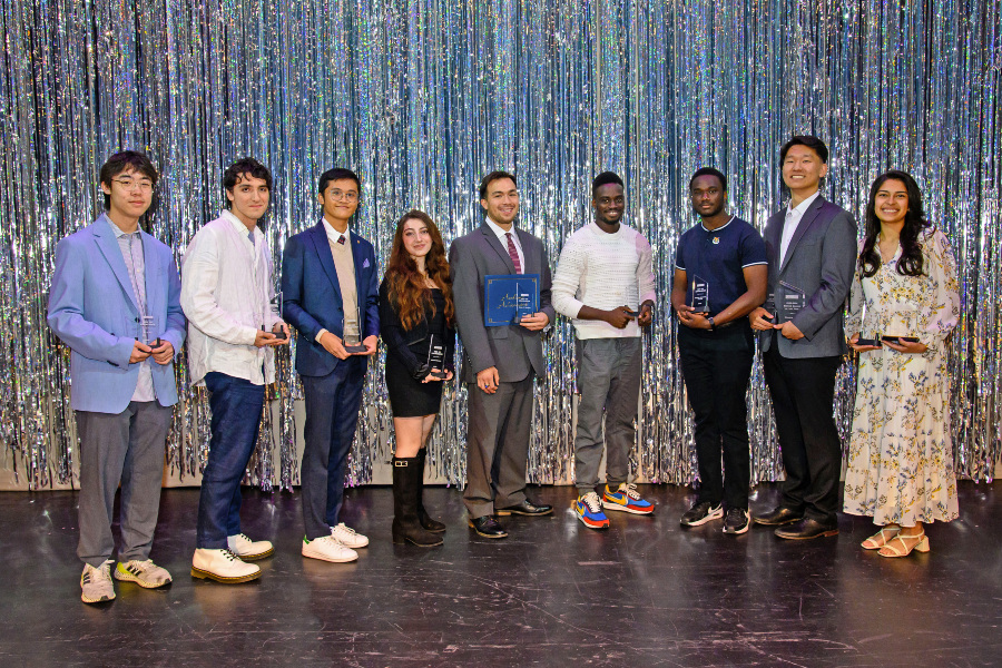 students hold awards on stage during the citrus college achievement awards ceremony