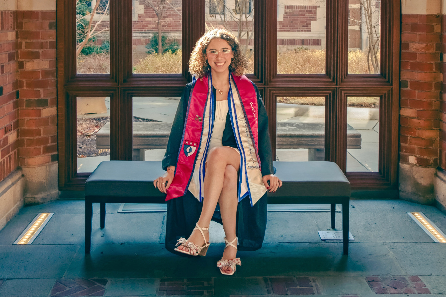 paulina pimentel-mora sits in graduation regalia after earning her degree from yale university