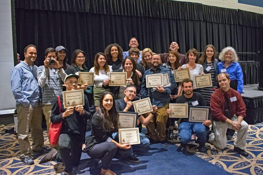 student journalists and faculty members pose with awards after a journalism conference recognition event