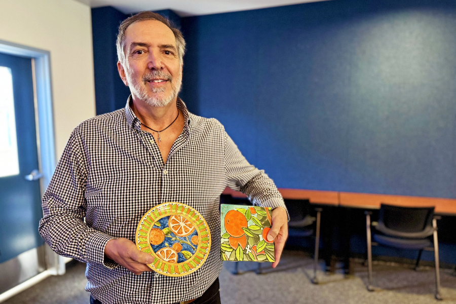 michael hillman holds tile and plate ceramic creations