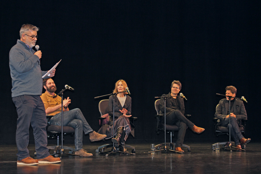 a moderator addresses four music industry panelists during the master class on the music business at the haugh performing arts center