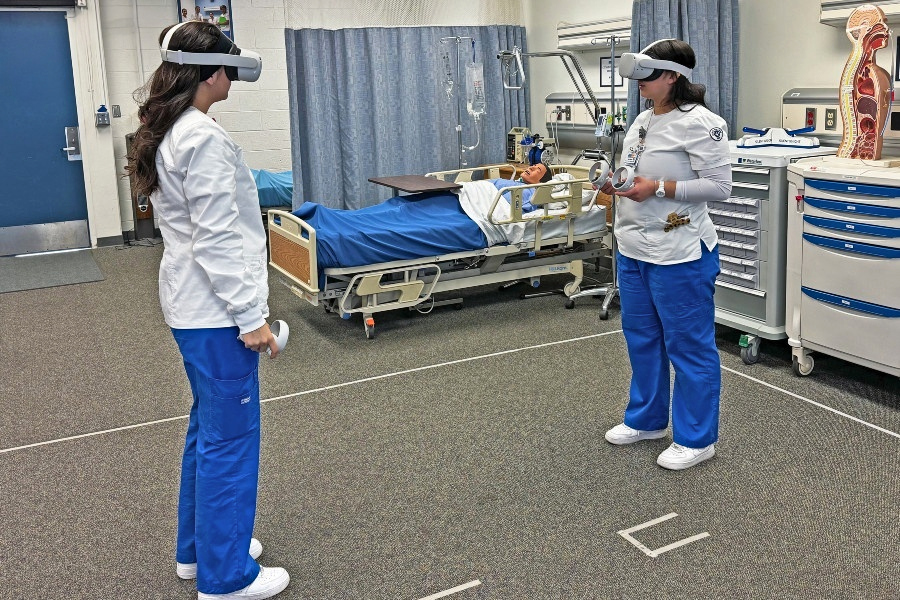 nursing students wearing virtual reality headsets during a simulation training exercise in a clinical lab