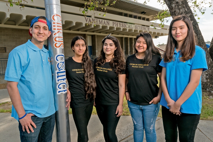 five citrus college rocket owls team members standing beside a student built rocket outside the vaniman physical science building
