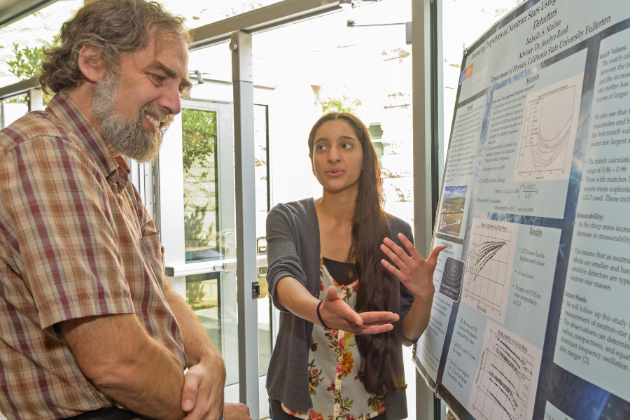 student presents a research poster to a faculty member during the citrus college stem research symposium