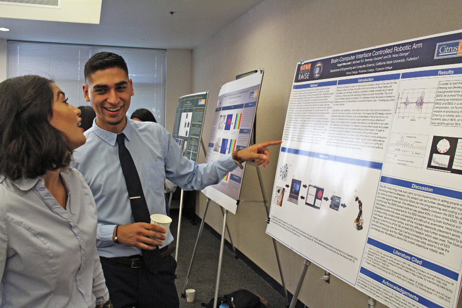 two citrus college students discuss a brain-computer interface research poster during the stem research symposium