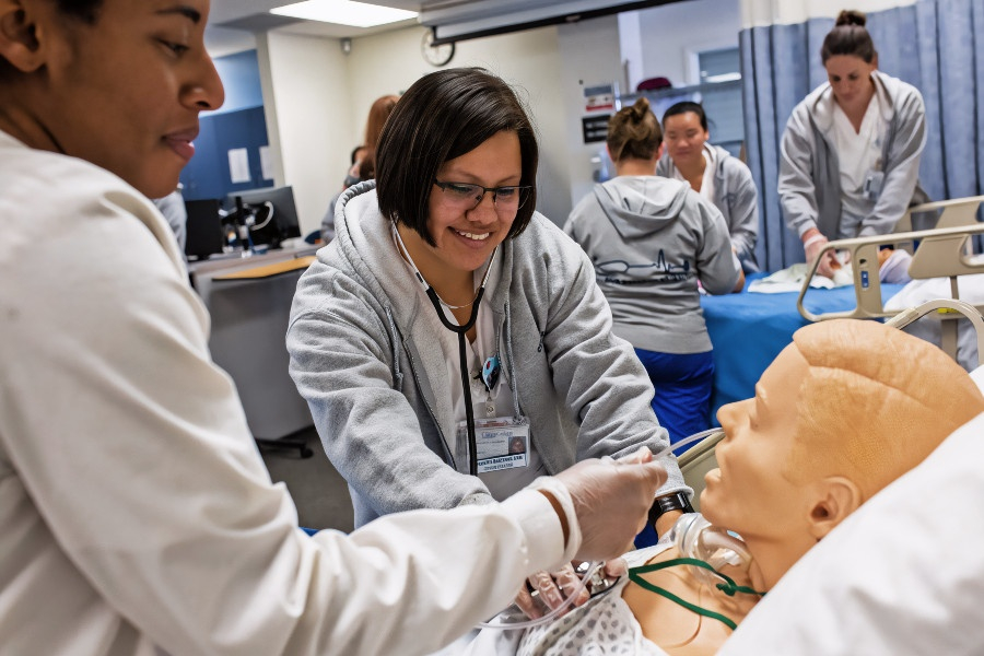 ADN students using medical training manikins in their classroom