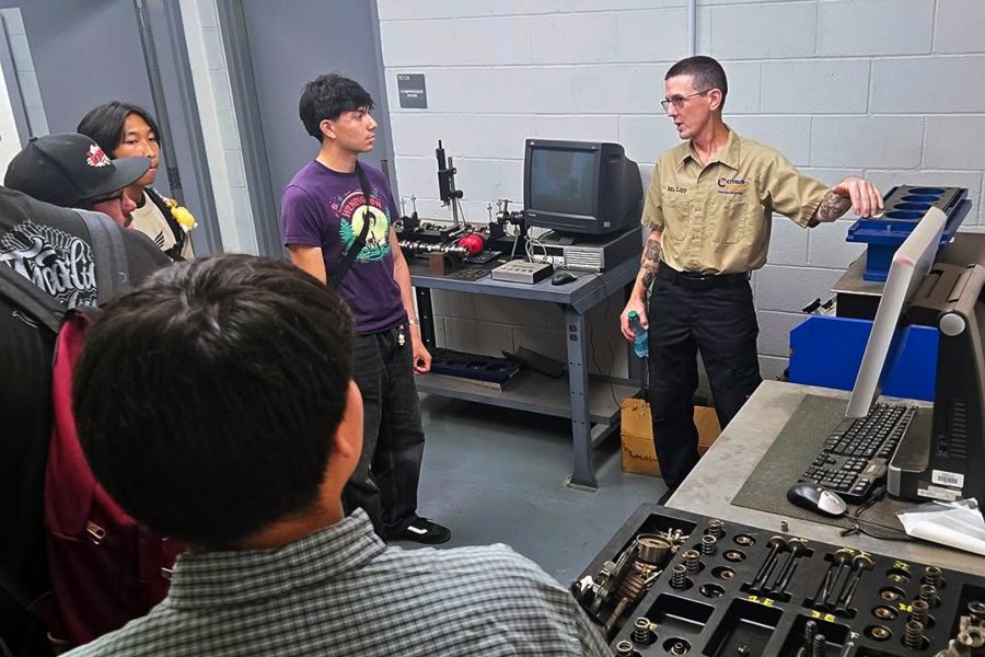 greg lipp explains automotive diagnostic equipment to azusa high school students inside a citrus college automotive laboratory