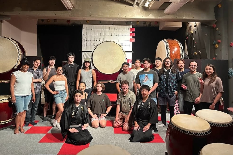 citrus college study abroad students and instructors pose with japanese taiko drummers in a studio surrounded by large traditional taiko drums after participating in a drumming activity in osaka, japan