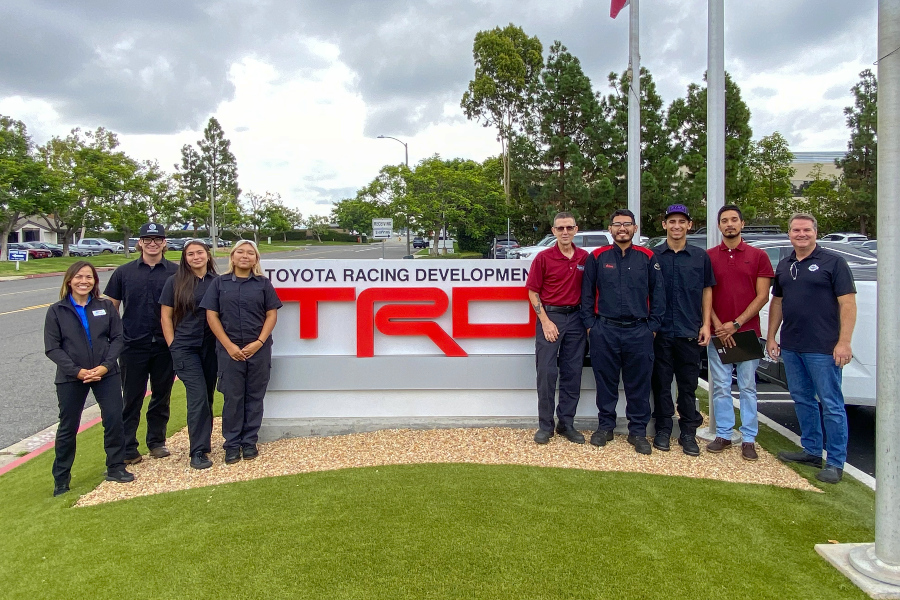 citrus college automotive technology students and faculty stand in front of the toyota racing development sign during a facility tour
