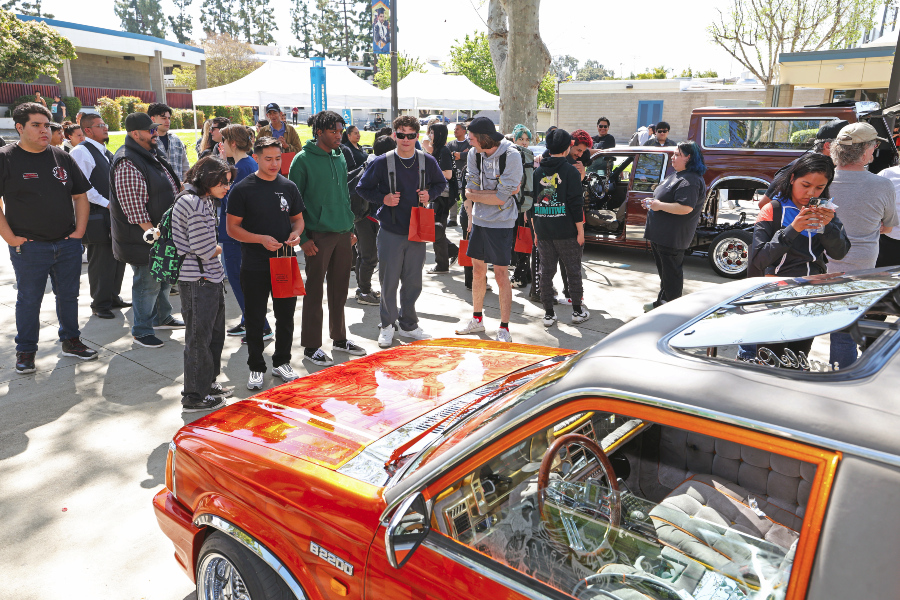 students gather in the campus mall to view lowriders during a citrus college auto tech event
