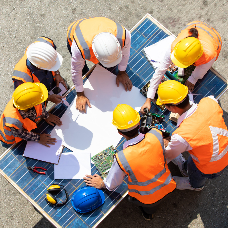 construction crew in the field reviewing plans