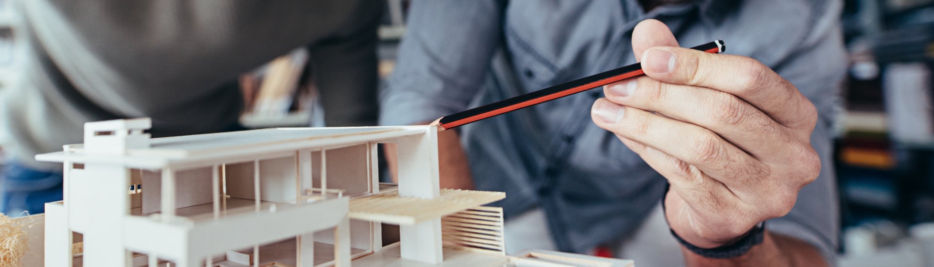 architecture student with a three dimensional model of a home