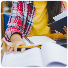 image of a student with her laptop and notebook