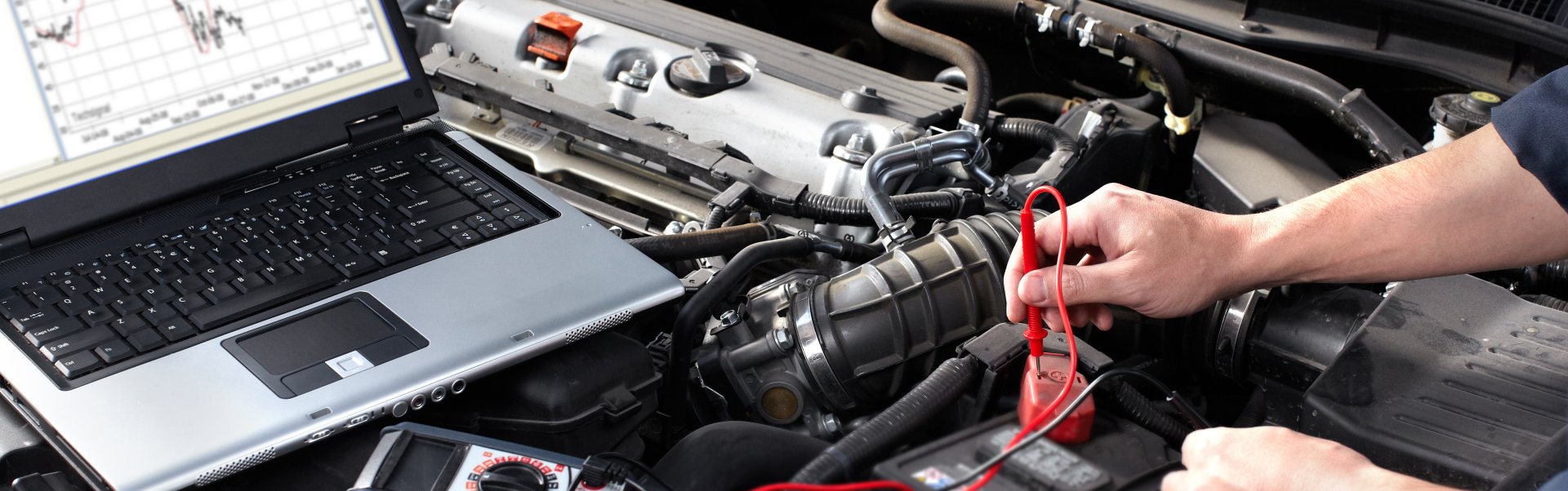 student running computer diagnostic on auto charging system