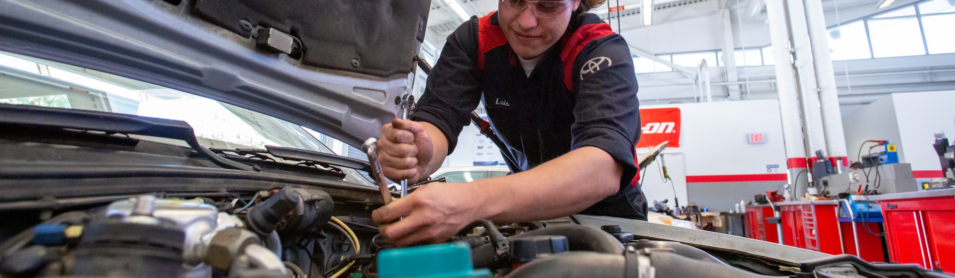 student technician works underhood