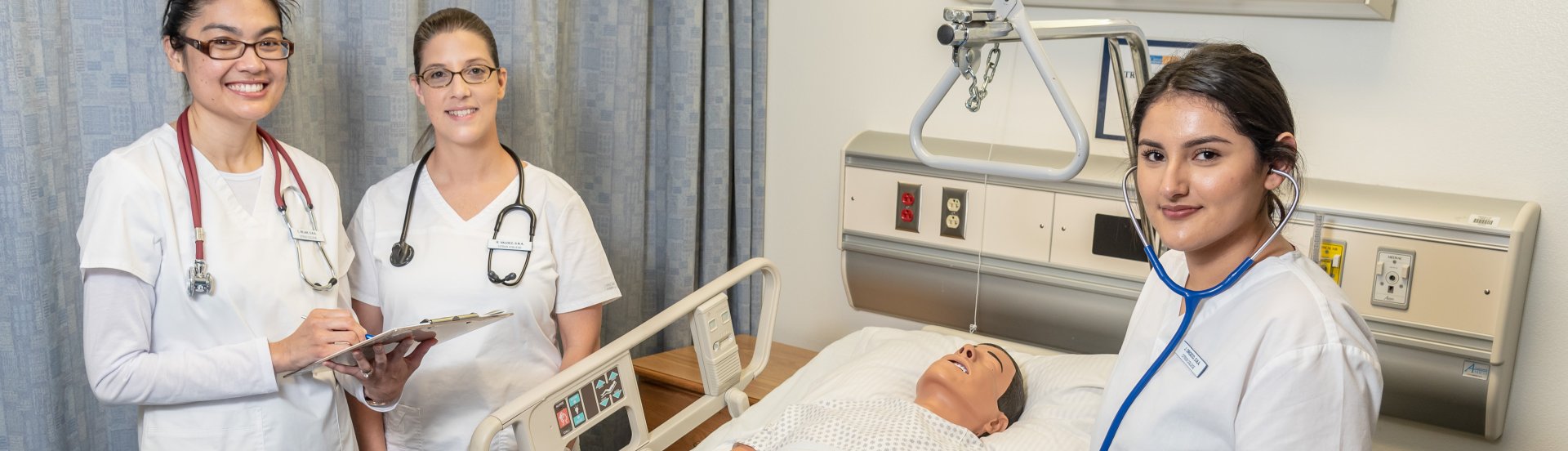 Nurse Assistant listening to heartbeat of patient with stethoscope