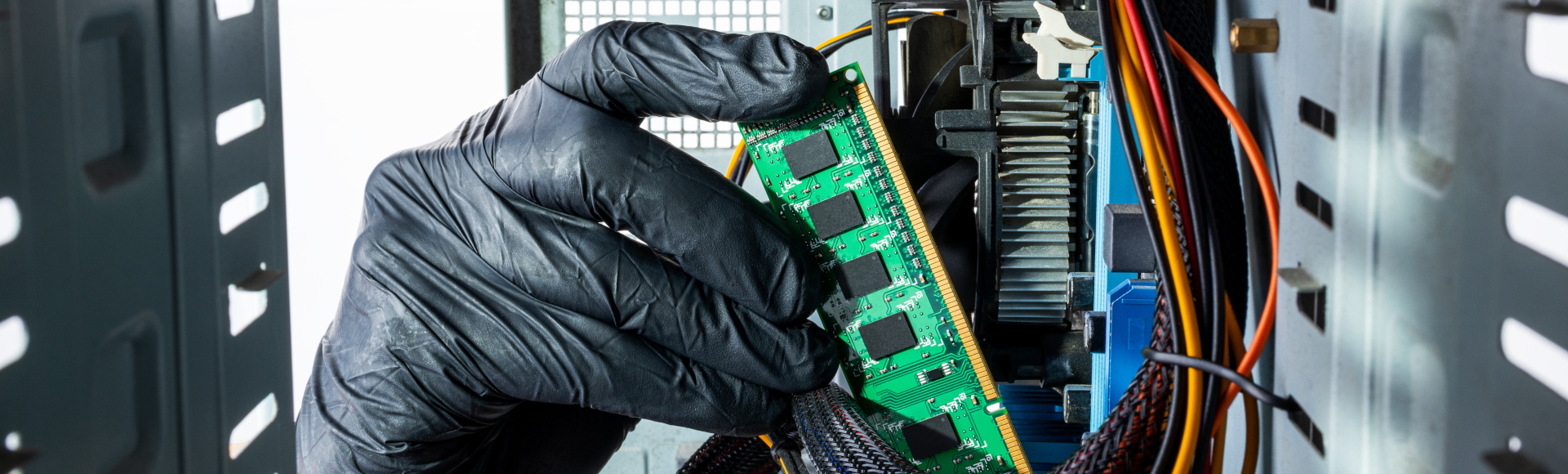 view from inside of a computer showing a technician replacing a circuit board