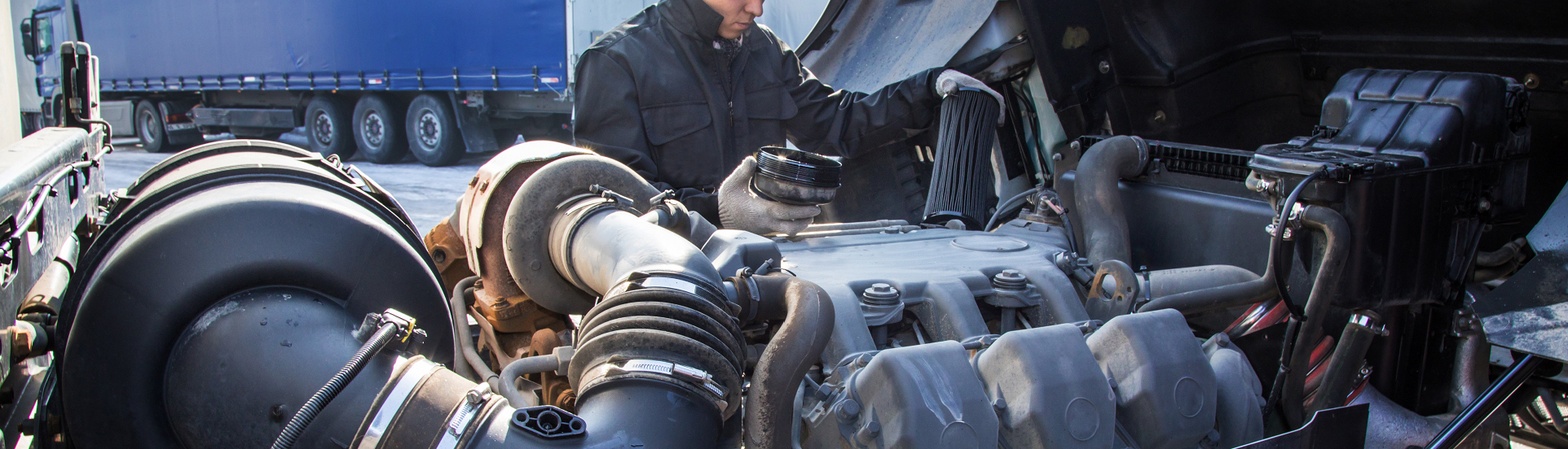 student working underhood on diesel truck