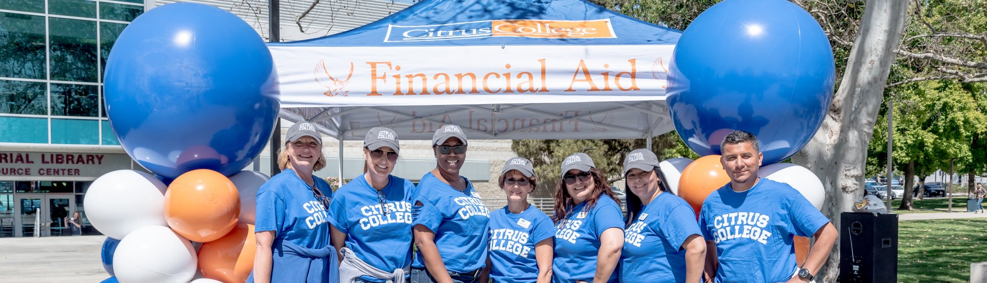 financial aid staff members at a student event at the college's outdoor campus mall