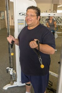 Male student using fitness equipment