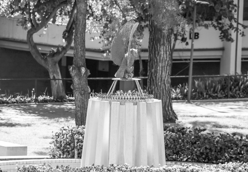 black and white photo of the Fighting Owl sculpture sitting atop the campus fountain