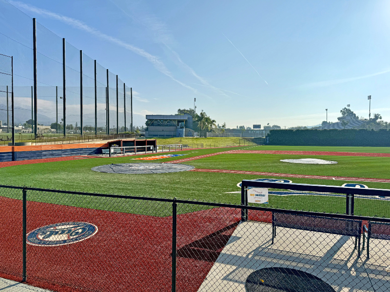 a view of the ball field looking east from the opposing team's dugout 