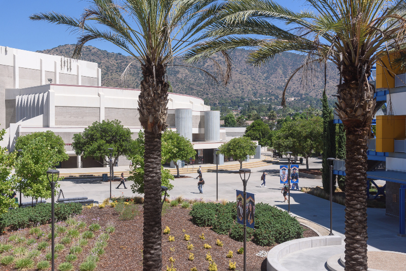View of the forecourt from the second floor of the Visual Arts Building, facing north with the Haugh Performing Arts Center and the San Gabriel Mountains in the background