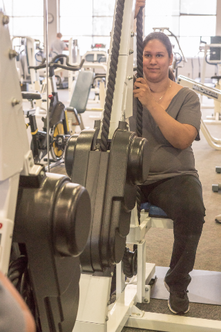 student at an upper-body strength machine
