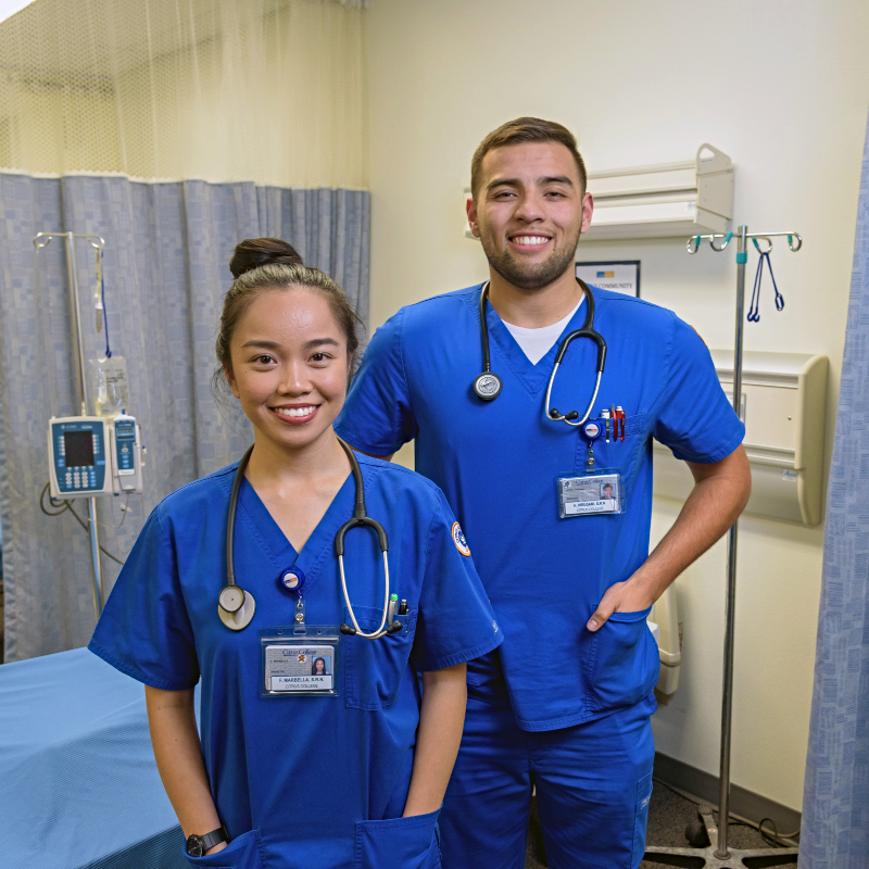 two nursing students pictured among healthcare equipment