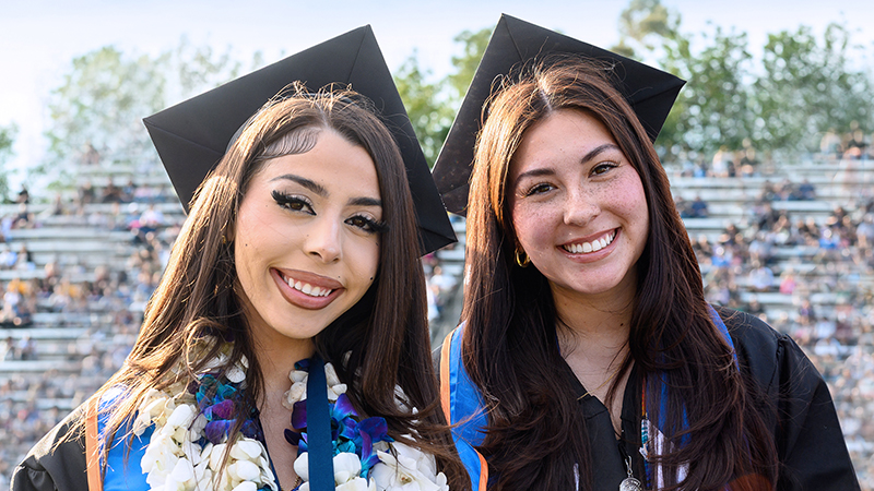 Two graduating Citrus College students at commencement