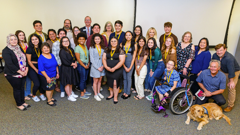 group of honors students with college administrators
