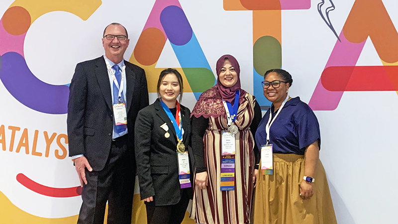 Citrus College employees and a Citrus College student pose with the college's president, Dr. Greg Schulz