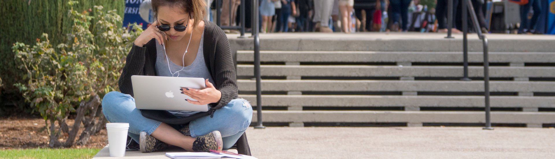 Student studying with her laptop near the Campus Center mall