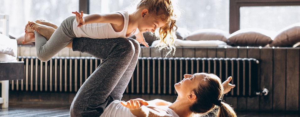 woman doing yoga with small child