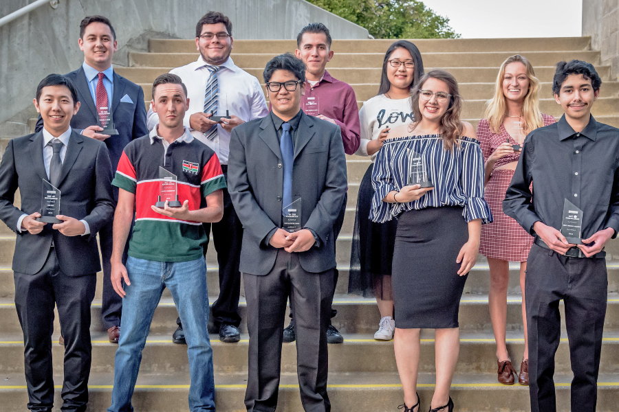 ten citrus college students pose on outdoor steps while holding awards from the achievement awards ceremony
