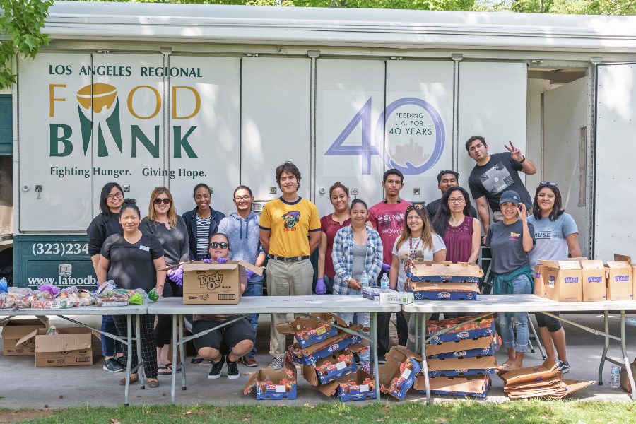 volunteers distributing food in front of a Los Angeles Regional Food Bank truck on campus