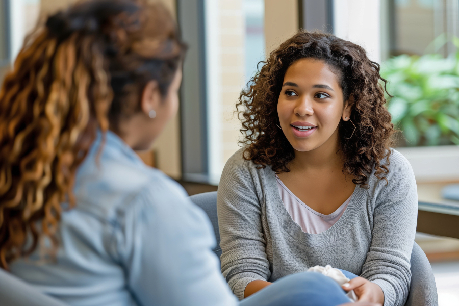 student speaks with a counselor during a mental health support appointment on campus