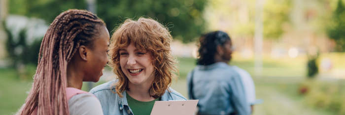 Two female students chatting and laughing