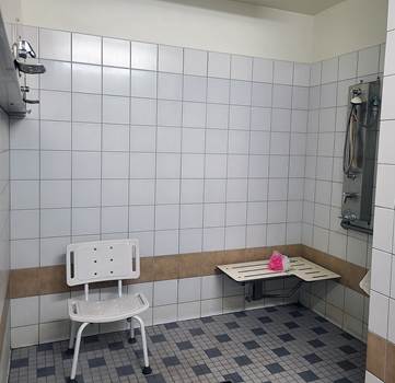 accessible shower showing bench and handheld showerhead