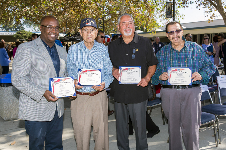 four veterans hold certificates of recognition during the saluting our veterans ceremony at citrus college