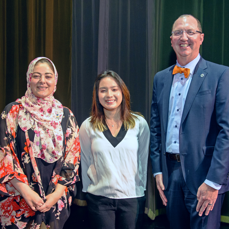Areej Qasqas, part-time faculty (far left); student Jessie San (center); Dr. Greg Schulz, superintendent/president (far right)