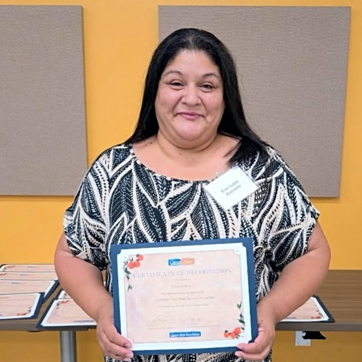 Eva Buyher holding a certificate of acknowledgement